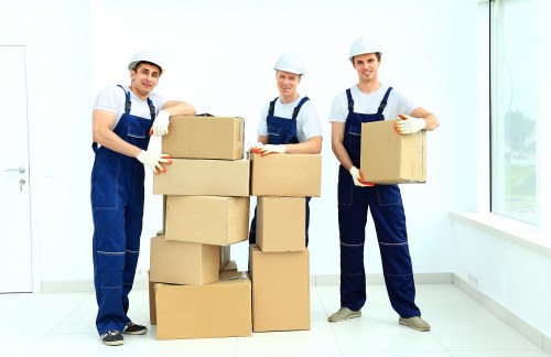 Professional removals crew working carefully in a protected environment