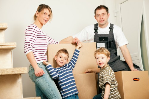 Prepared moving boxes and furniture beside a hired removal truck in Italy