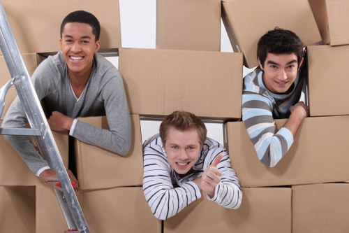 Staff handling boxes and furniture carefully during a removal