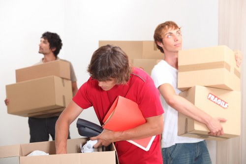 Removal truck loading boxes and household items for a move in Italy