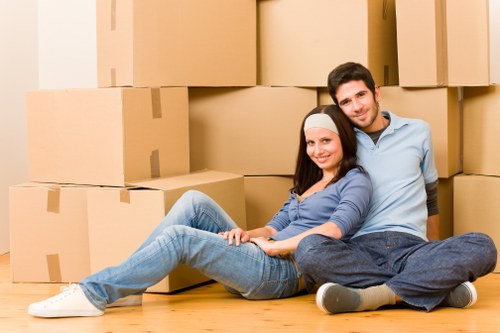 House removals team handling furniture in an Italian city apartment