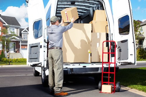 Organized business relocation with boxes, desks, and IT equipment being moved